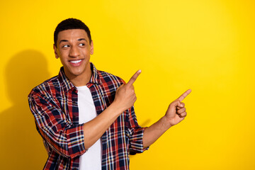 Photo of nice cheerful man wear stylish clothes look empty space solated on yellow color background