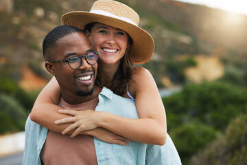 Interracial couple, trip and happy for hug in nature, travel and countryside for vacation in...