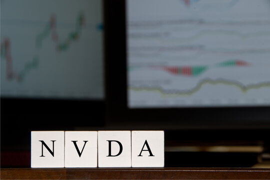  Financial ticker NVDA image, term used in market chat. Business setting, computer screens, displaying financial graphs.
