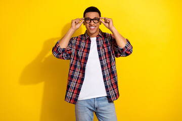 Photo of nice young man toothy smile touch glasses wear shirt isolated on yellow color background