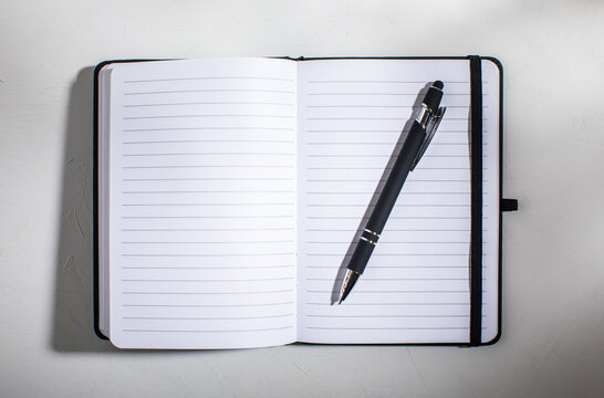 Open lined notebook with pen