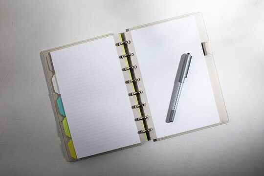 Open lined notebook with pen
