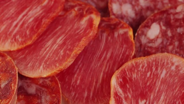 Mix of spanish pork sausages, Cutting board of appetizing catalonian snack - fuet, jamon, chorizo, olives, supermarket tapas food in spain, traditional cuisine. 