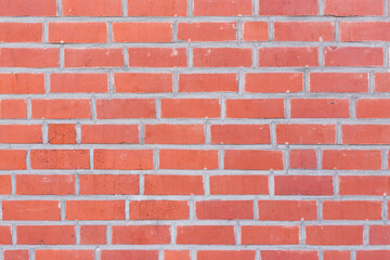 Red brick wall texture background. Pattern with narrow brown bricks.