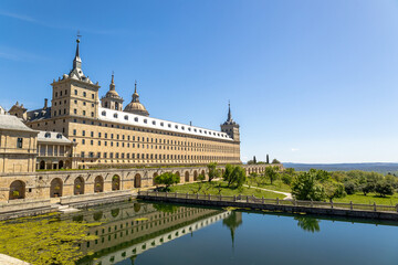 Real Monasterio de San Lorenzo de El Escorial historic building with gardens landscaped plants with artificial lake Madrid, Spain