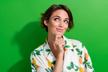  Photo of excited dreamy girl dressed print shirt arm chin looking empty space isolated green color background © deagreez