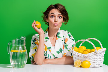 Photo of spring sour lemons grown young girl collect fresh fruits every year harvest make juice isolated on green color background - obrazy, fototapety, plakaty