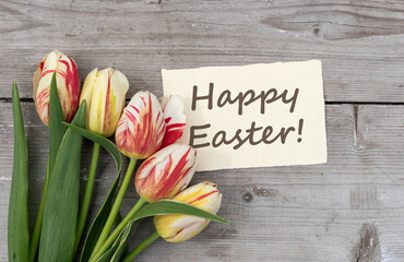 Greeting card with red, yellow and white tulips and English text: Happy Easter
