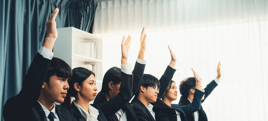 Business team or office workers raising their hands in seminar or business workshop training to ask...