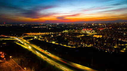 Drone photo huge multi-lane circle roundabout intersection in city traffic highway night city....