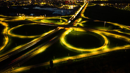 Aerial view huge multi-lane circle roundabout intersection in city traffic highway night city....