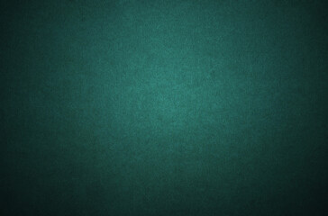 A sheet of dark green cardboard texture as background
