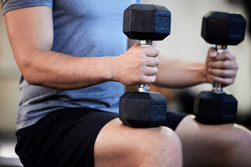 Athletic, man and legs with dumbbells for fitness in gym for goals with weightlifting for health....