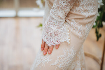Bride in white lace gown with long sleeves at wedding ceremony
