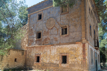 Beautiful abandoned country house in the forest, on a sunny morning