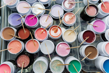Various paints in hues like pink, violet, and magenta