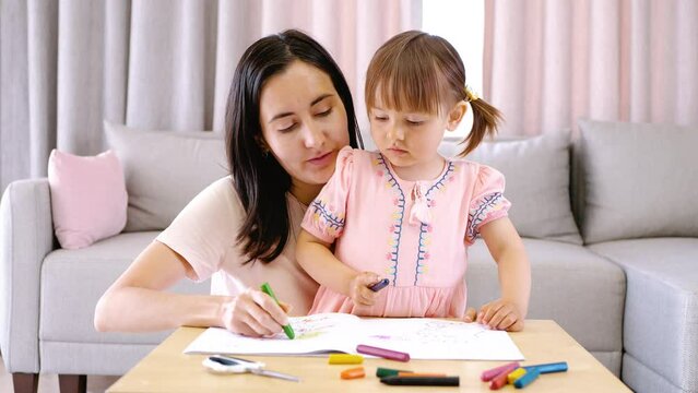 Mom conducts home activities with her child. Raising and developing toddlers.