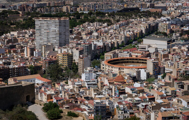 Fototapeta premium a view of the bull ring (Placa de bous, toros, corrida) and characteristic Spanish buildings seen from Santa Barbara Castle (Alicante, Costa Blanca, Spain)