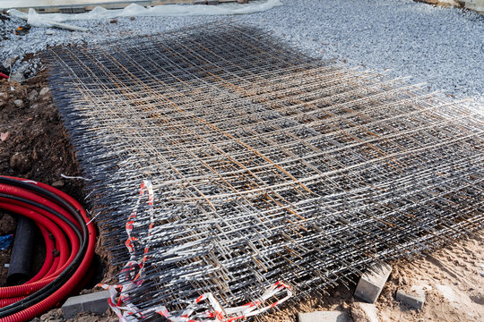 Wire mesh stacked on dirt pile for construction or fencing project