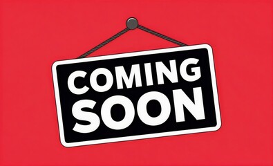 Black and white sign with 'Coming Soon' text hanging on a red background, label on a wall, business concept