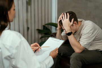 Stressed and depressed patient seeking help from psychiatrist with mental illness and depression in...