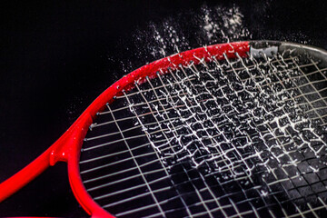 Bouncing white powder on a red racket