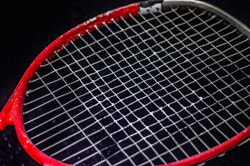 Red tennis racket with white powder
