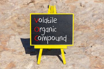 Fototapeta premium VOC volatile organic compound symbol. Concept words VOC volatile organic compound on beautiful yellow blackboard. Beautiful stone background. Business VOC volatile organic compound concept. Copy space
