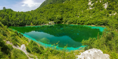 Scenic view of turquoise colored Lake Cornino near Udine in Friuli-Venezia Giulia, Italy, Europe. Peaceful serene scene on Alpe Adria trail in Italian Alps. Calcium sulphate gypsum in water. Awe - obrazy, fototapety, plakaty