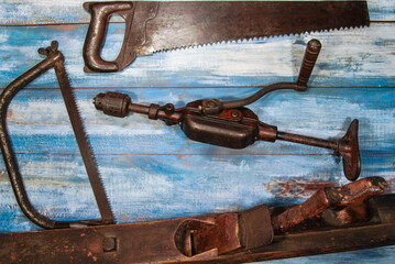 old carpentry tools on a background on blue boards