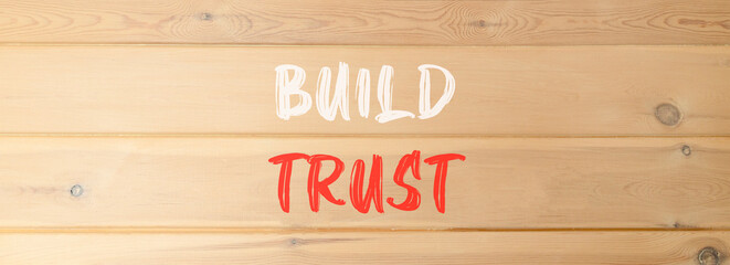 Build trust symbol. Concept words Build trust on beautiful wooden wall. Beautiful wooden wall...