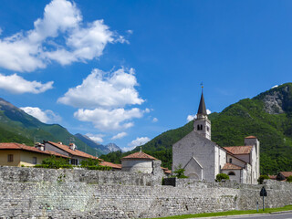 Fototapeta premium Scenic view of the old town of remote mountain village Venzone, Val Canale valley, Udine, Friuli Venezia-Giulia, Italy, Europe. Ciclovia Alpe Adria bike trail along the river Tagliamento