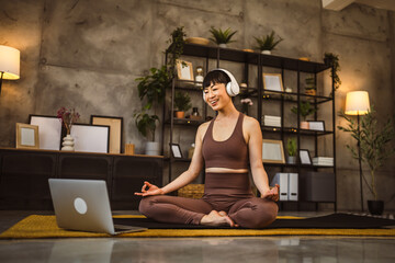 one japanese woman practice guided meditation at home use headphones