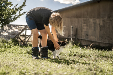Child Playing With Barn Cat Kids and Pets Love Comfort