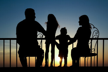 Happy family at the dawn of the sea silhouette background