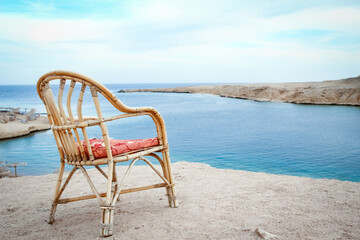 Stylishly beautiful chair on the sea nature landscape background