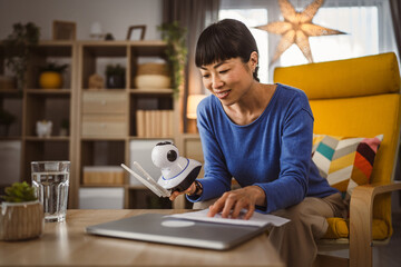 mature japanese woman adjust prepare home surveillance security camera