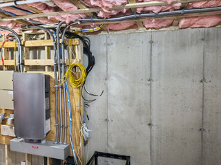 Rooftop solar system and storage batteries connected via system controller in basement utility room