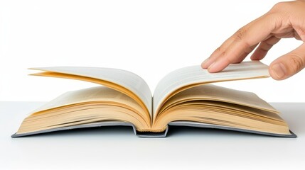   A hand holding an open book against a white backdrop