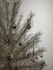 Partial view of a decorated glitzy silver Christmas tree