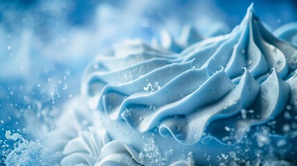   A tight shot of a frosted cupcake, adorned with icing and colorful sprinkles, against a blue backdrop - obrazy, fototapety, plakaty