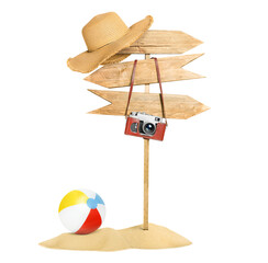 A wooden sign with a hat and a camera stands in a pile of sand next to an inflatable beach ball on white isolated background