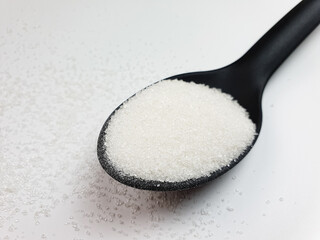 Spoonful of sugar. Sugar, additive, ingredient on white background.