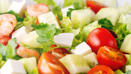 A close-up salad of fresh vegetables, a plate of fresh salad with vegetables and herbs. Greek salad...