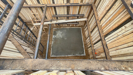 Deep pit for utilities, construction of external heating and sewerage networks. The pit is fenced with a protective wooden fence against soil collapse.