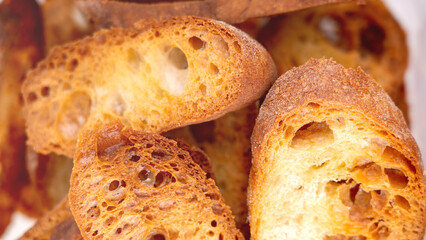 Close-up of baguette croutons, Toasts, bruschetta from sliced baguette, close up view, Toasted baguette slices isolated on white background close up. Toast, crouton. Top view.