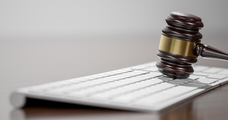 Gavel at the computer keyboard: Legal and law concept. Wooden hammer of justice and order