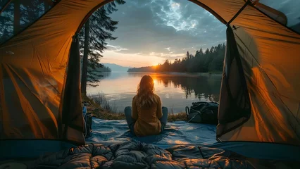 Fotobehang Girl enjoying sunset view by a lake while camping in a tent. Concept Sunset Views, Camping, Lake Vibes, Outdoor Adventures, Tent Life © Ян Заболотний