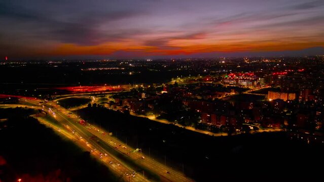 night video from aerial drone of city elevated toll road, ring road with interchange in Milan Italy. A51 Milan Eastern Ring Road