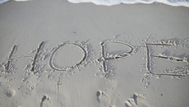hope written on a beach